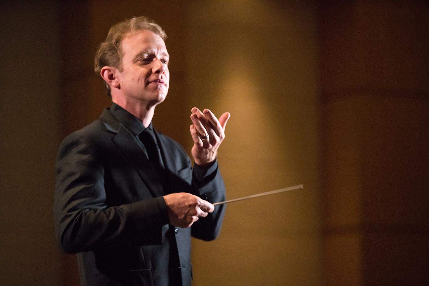 Maestro Heuser conducting and smiling