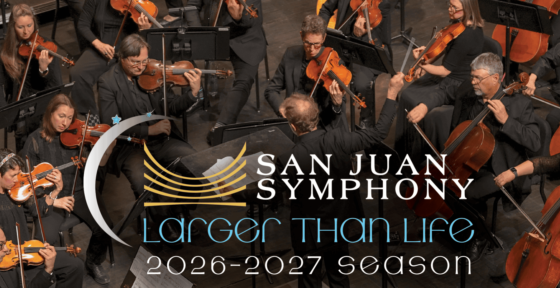 Full orchestra on stage led by a conductor, with a banner reading 'San Juan Symphony' and 'Larger Than Life' across the front. (Season 2026–2027)